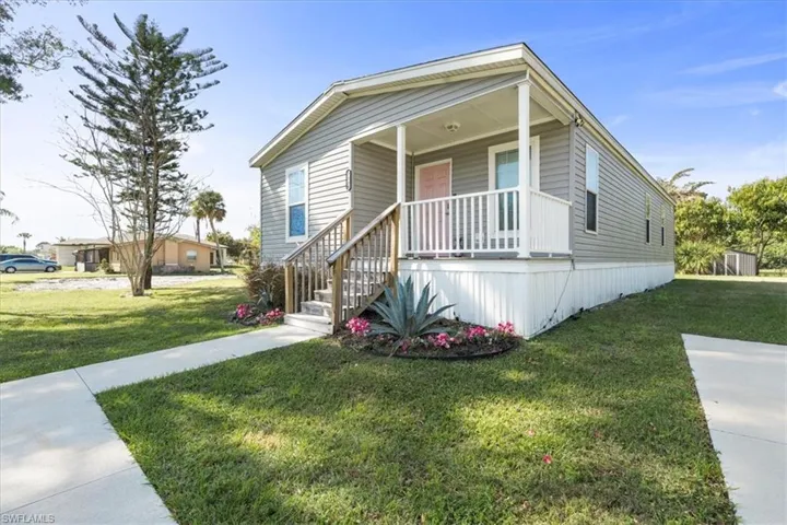 View of front of house featuring a front yard and a porch