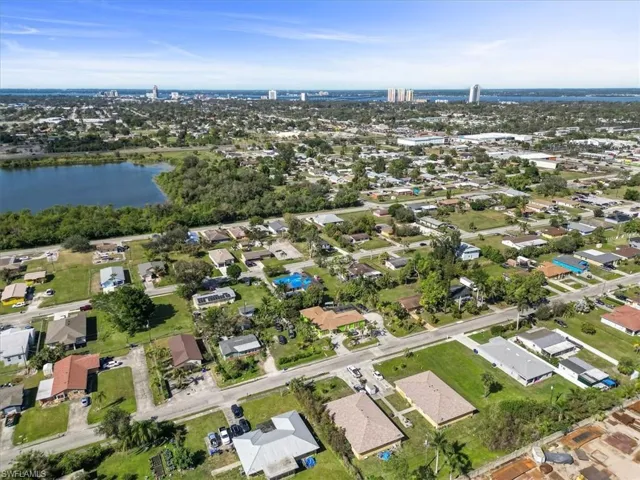 Birds eye view of property with a water view