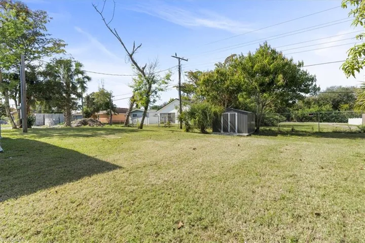 View of yard with a storage unit