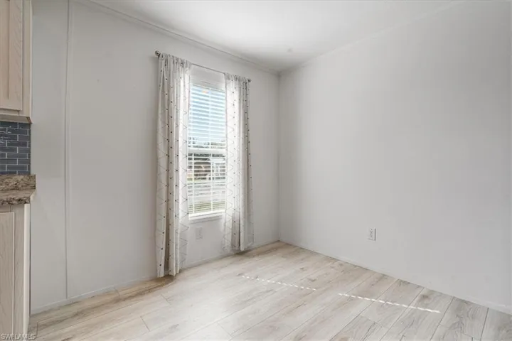 Unfurnished room featuring crown molding and light hardwood / wood-style floors