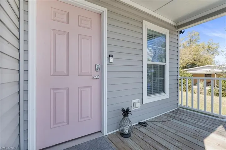 Doorway to property with covered porch