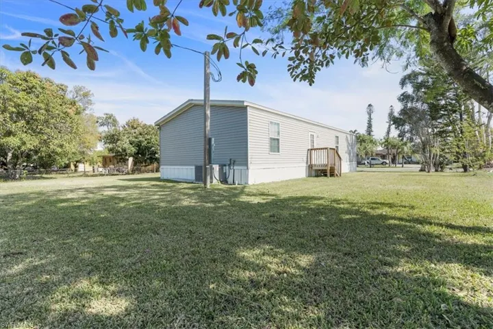 View of side of property featuring a yard