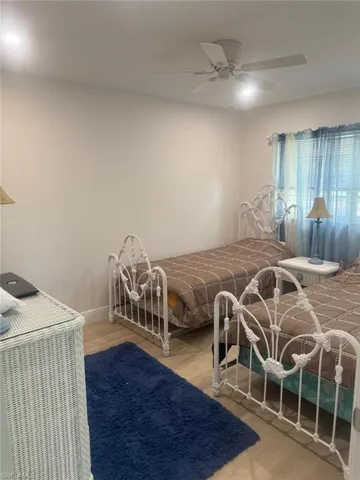 Bedroom with wood finished floors and ceiling fan