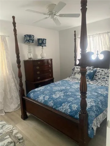 Bedroom featuring wood finished floors and a ceiling fan