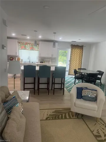 Living room featuring light wood-style flooring and recessed lighting