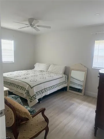 Bedroom with wood finished floors and a ceiling fan