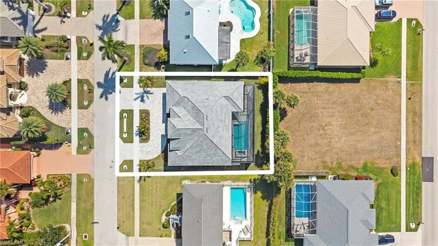 Aerial view of residential area featuring a pool area