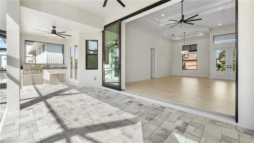 View of patio / terrace featuring ceiling fan, french doors, and an outdoor kitchen