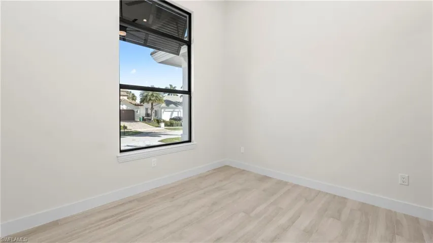 Unfurnished room featuring baseboards and light wood-style flooring