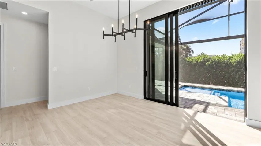 Unfurnished dining area with light wood-style flooring and a chandelier