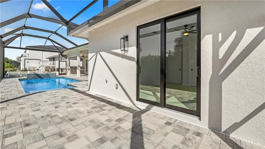 Integrated pool / spa featuring a patio area, a sunroom, and a lanai