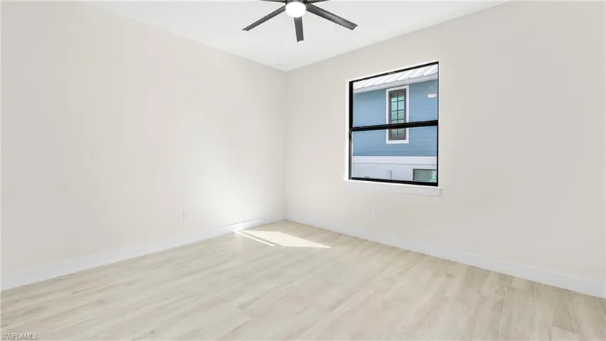 Spare room featuring light wood-style flooring and a ceiling fan