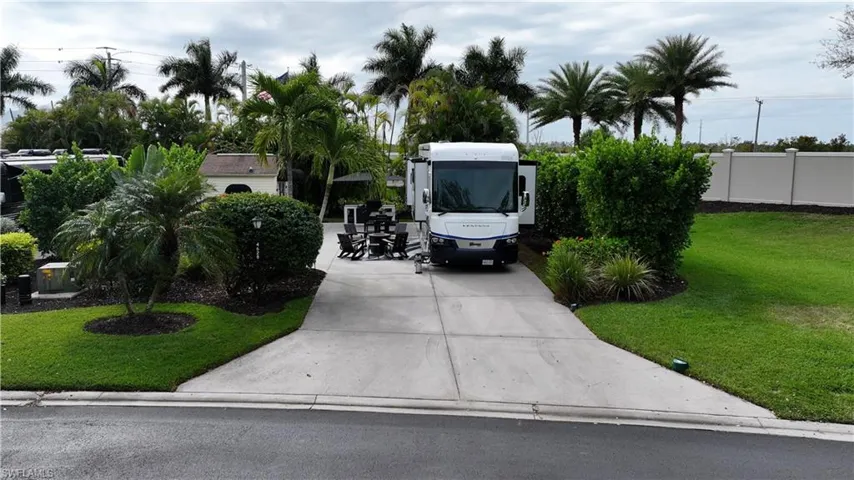View of vehicle parking featuring concrete driveway