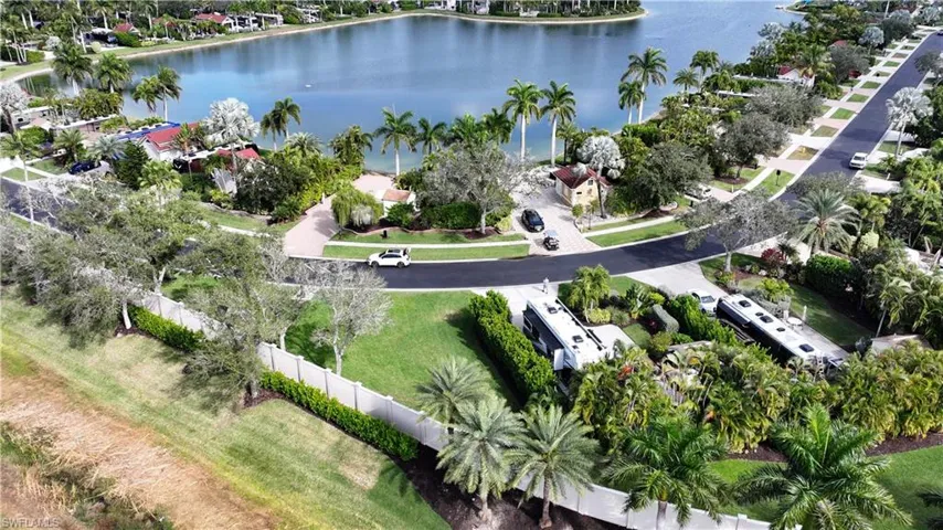 Aerial view of property and surrounding area with a nearby body of water