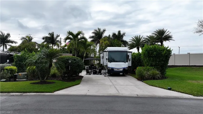 View of parking with concrete driveway