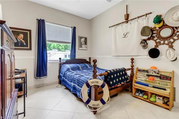 Bedroom with light tile patterned flooring