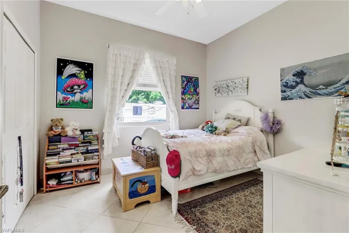 Bedroom featuring ceiling fan, a closet, and light tile patterned floors