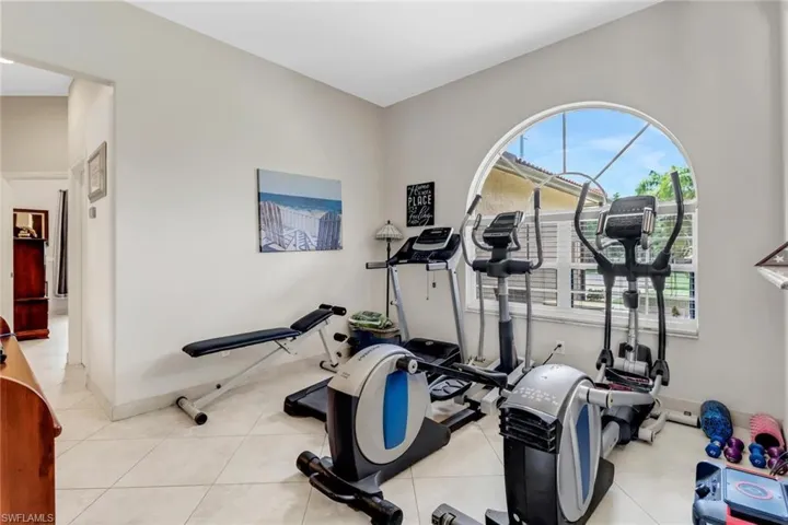 Workout area with light tile patterned floors