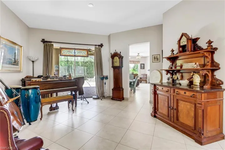 Sitting room with light tile patterned floors and ceiling fan