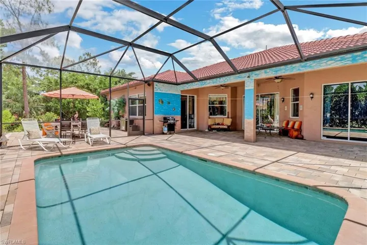 View of swimming pool featuring a patio, and screened enclosure