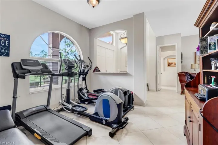 Workout area featuring light tile patterned flooring