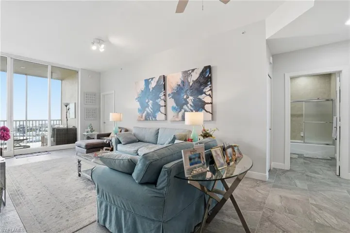 Living area with floor to ceiling windows and ceiling fan - Virtually Edited Image