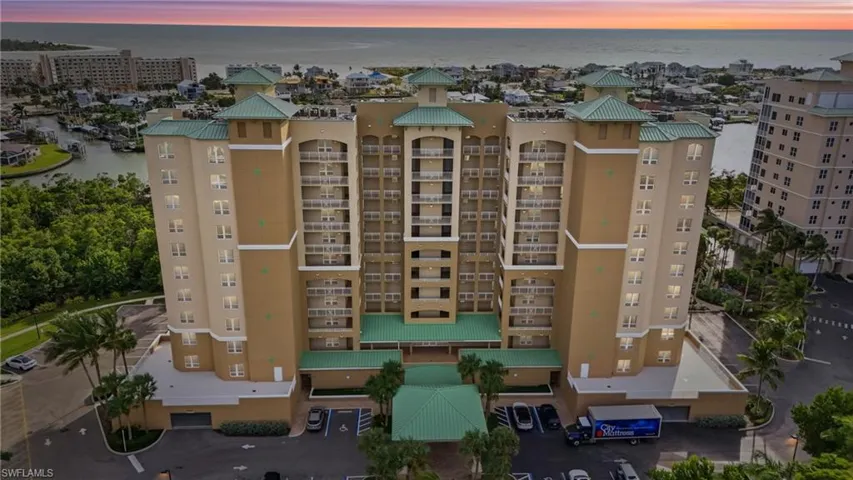 View of apartment building / complex featuring a water view - Virtually Edited Image