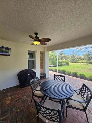 View of patio / terrace with area for grilling, a ceiling fan, and outdoor dining area