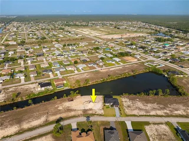 View of property location with a large body of water and nearby suburban area