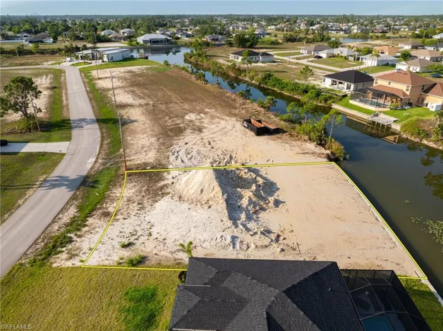 Aerial view of residential area featuring a large body of water
