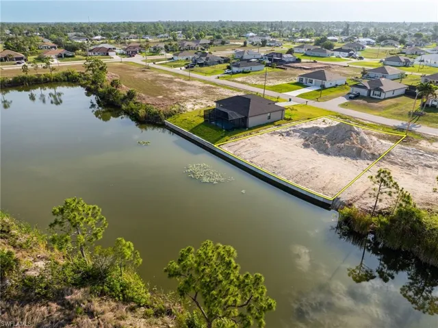 Aerial perspective of suburban area featuring a large body of water