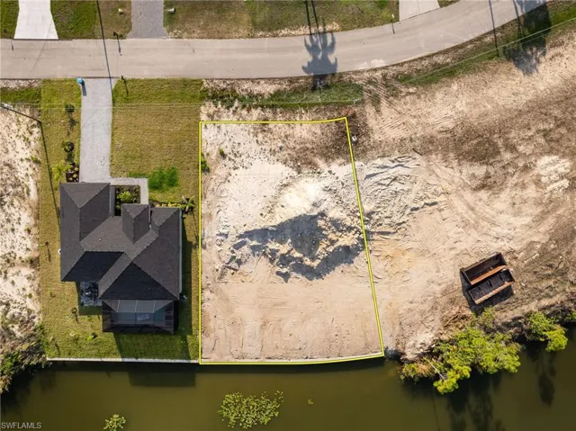 Aerial overview of property's location with property parcel outlined and a nearby body of water