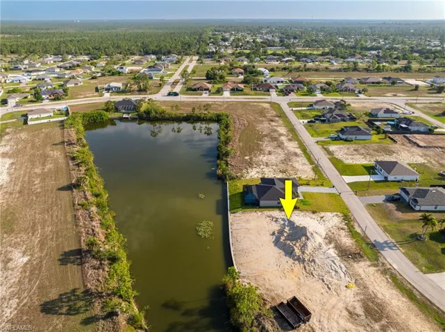 Aerial view of residential area featuring a large body of water