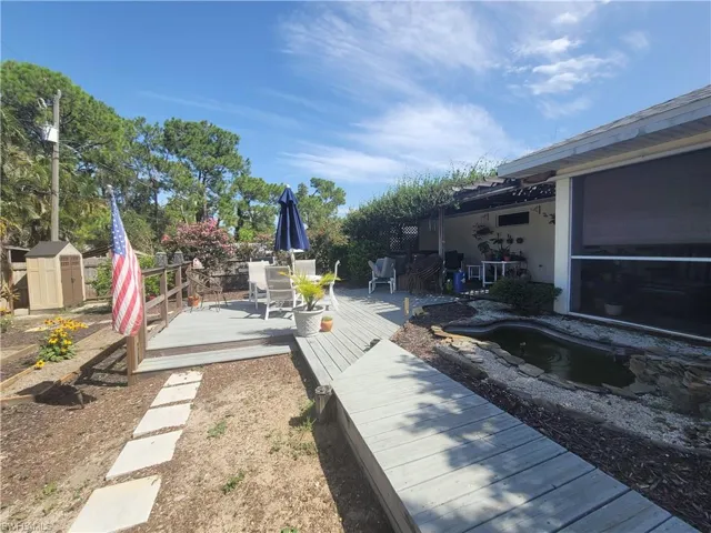 View of yard with a storage shed and a deck