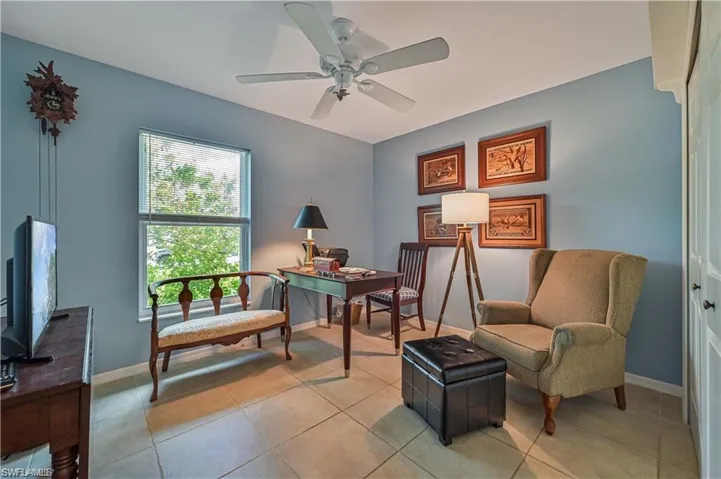 Sitting room featuring light tile patterned floors and ceiling fan