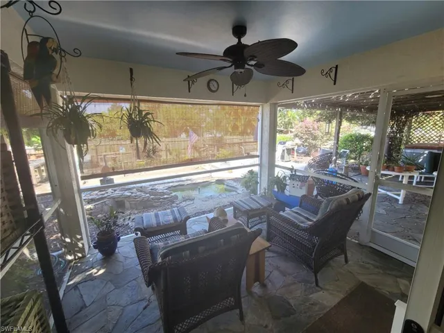 View of patio featuring an outdoor living space, ceiling fan, and a swimming pool