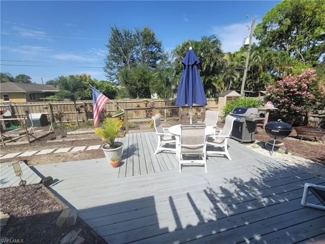 Wooden deck featuring a grill