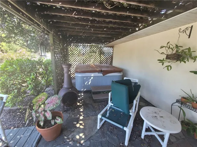 View of patio / terrace with a deck and a hot tub