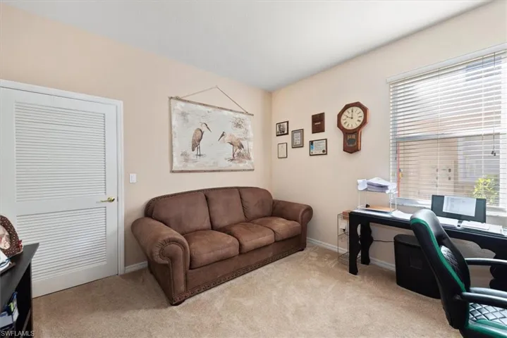 Carpeted office featuring baseboards