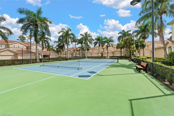 View of tennis court featuring a residential view and community basketball court