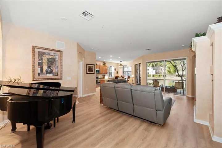 Living area featuring light wood finished floors and recessed lighting