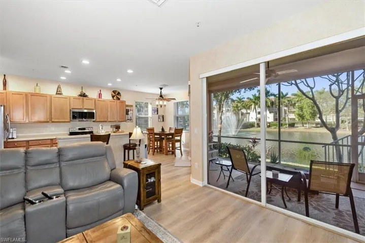 Living area with recessed lighting, light wood-style floors, a water view, and ceiling fan