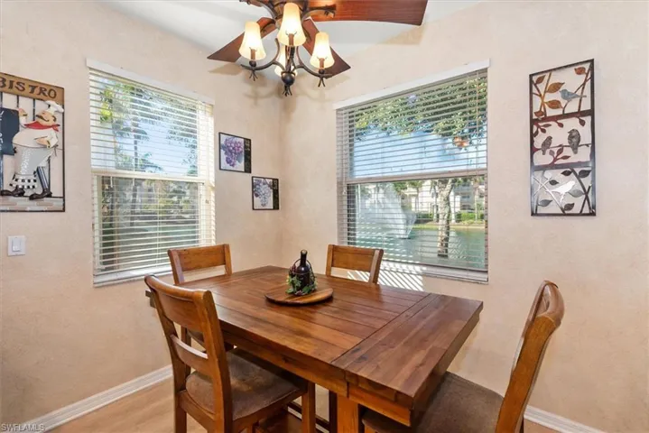 Dining area featuring a textured wall, plenty of natural light, wood finished floors, and a ceiling fan