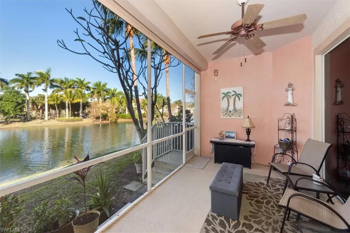 Sunroom / solarium featuring a water view and carpet flooring