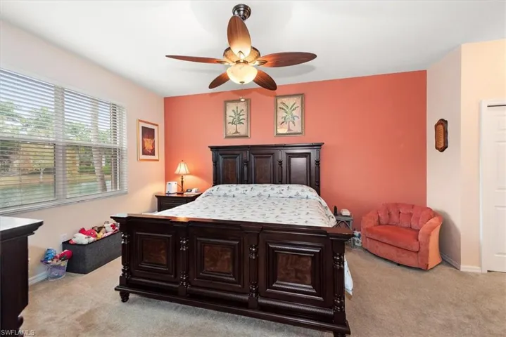 Bedroom featuring light colored carpet and ceiling fan