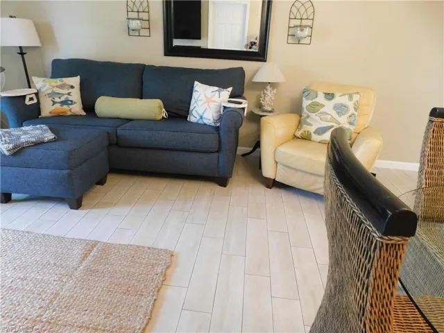 Living area featuring wood tiled floors and baseboards