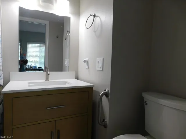 Half bathroom featuring toilet and vanity
