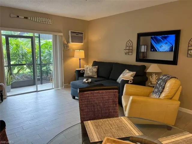 Living area with light wood finished floors and a textured ceiling