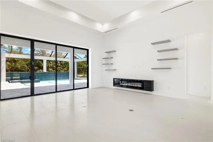 Tiled spare room with a tray ceiling