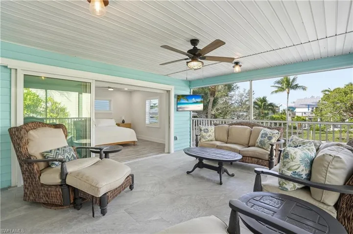 Sunroom / solarium with an outdoor living space and a ceiling fan - Virtually Edited Image
